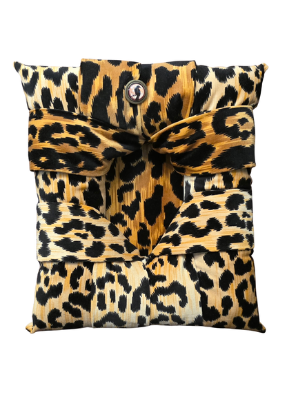  A handcrafted overstuffed picture frame in a velvet animal print fabric shown on a white background.