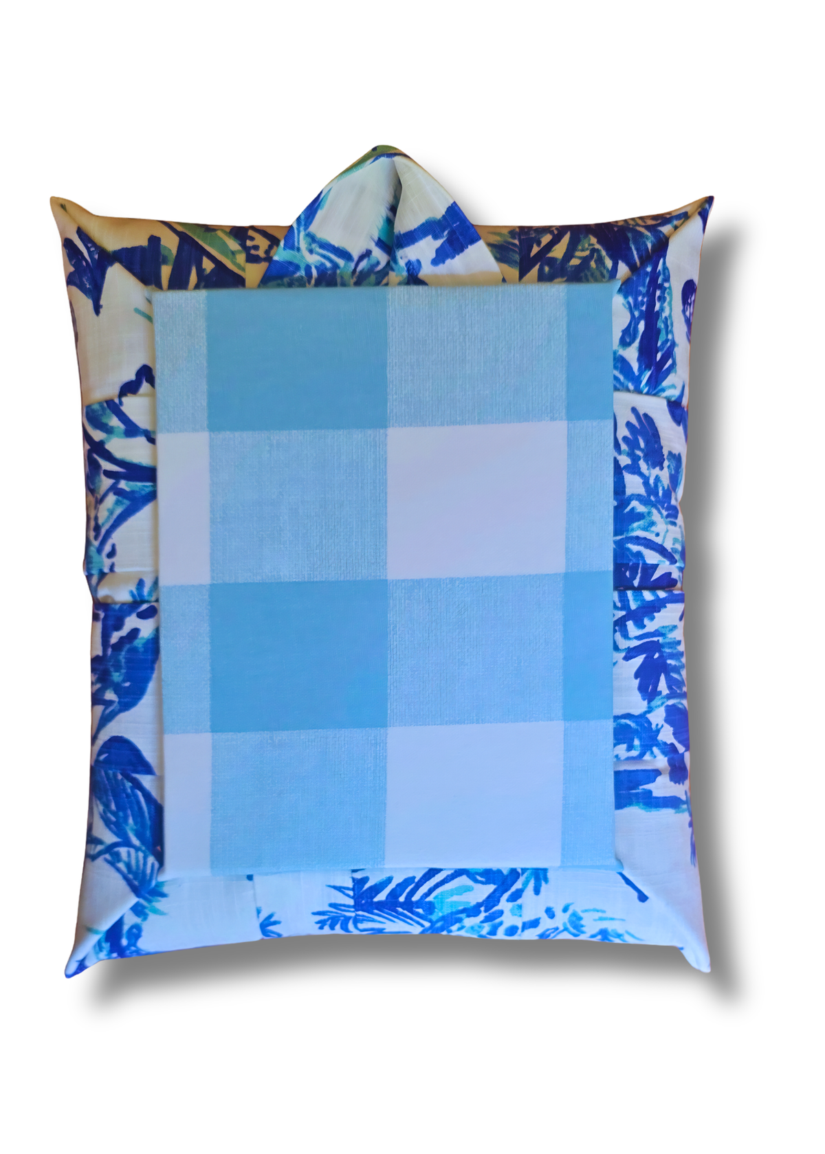 Back view of an overstuffed picture frame featuring a central light blue and white gingham check pattern surrounded by a blue and white tropical leaf print border, shown on a white background with a drop shadow.