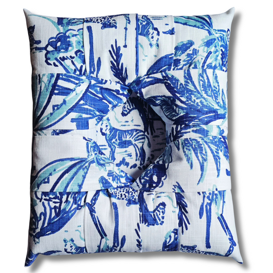 The front view of an overstuffed picture frame featuring a blue print of animals on the tropical grasslands of the savanna against a white background, with a central picture inset showing zebras in the tropical setting.