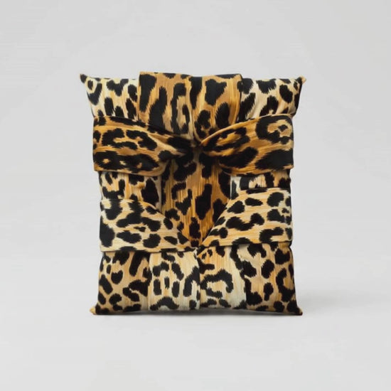 A video showing a handcrafted overstuffed picture frame with a velvet animal print fabric being slowly enveloped by a jungle scene with jungle sounds and music in the background. Heading says Primal Attraction - Love at First Sight.
