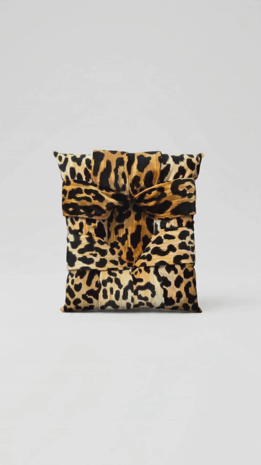 A video showing a handcrafted overstuffed picture frame with a velvet animal print fabric being slowly enveloped by a jungle scene with jungle sounds and music in the background. Heading says Primal Attraction - Love at First Sight.